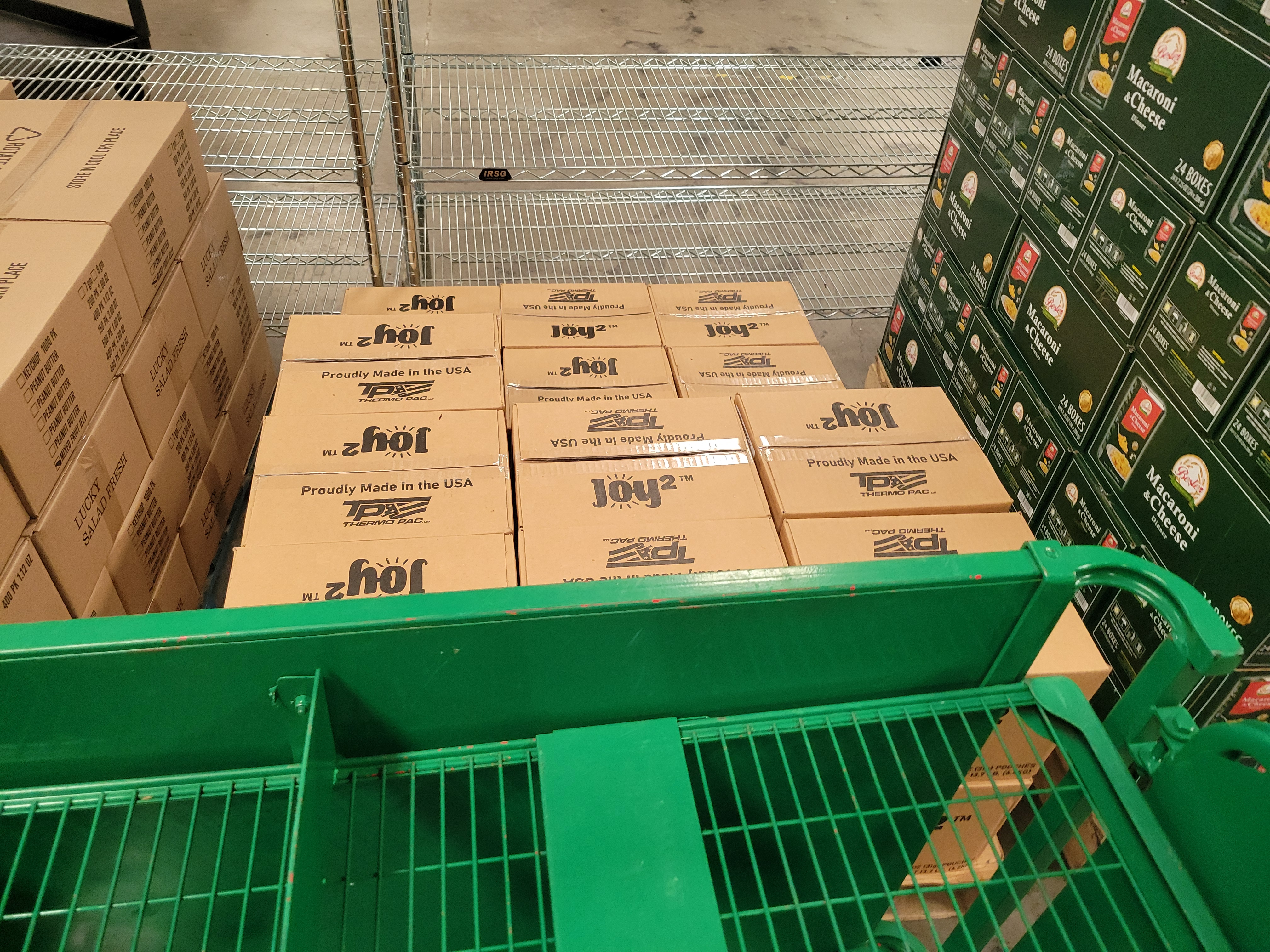 A pallet of jelly, a pallet of peanut butter, and pallet of mac n cheese.